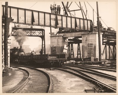 Workers Standing on Trestle as Train Passes Underneath in Unidentified Train Yard by William G. Swekosky